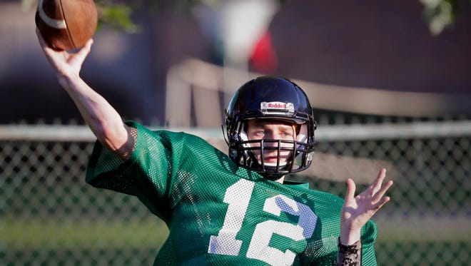 Whitefish Bay Dominican quarterback Bo Bennett completes a pass during practice on Monday.