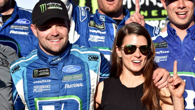 Ricky Stenhouse Jr. celebrates with Danica Patrick (10) after winning the 2017 GEICO 500 at Talladega Superspeedway.