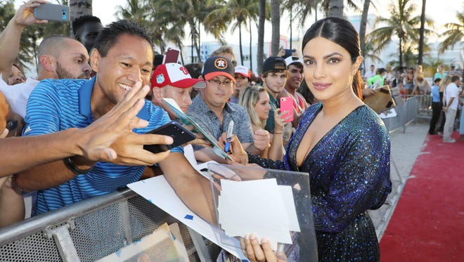 Priyanka Chopra signs autographs for fans on the 'Baywatch' red carpet.