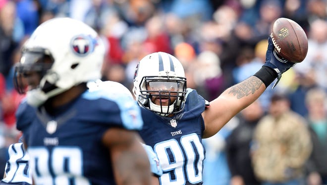 Tennessee Titans defensive end DaQuan Jones (90) holds the ball in the first quarter against the Houston Texans during the NFL game at Nissan Stadium.