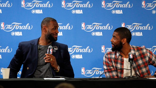 2016: LeBron James and Kyrie Irving react during a press conference.