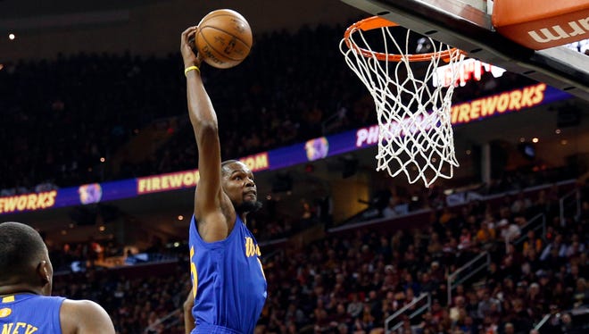 Golden State Warriors forward Kevin Durant (35) goes up for a dunk against Cleveland Cavaliers forward Kevin Love (0) at Quicken Loans Arena.