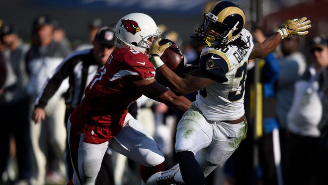 Rams running back Todd Gurley (30) is hit out of bounds by Cardinals linebacker Kevin Minter (51) during the second quarter.