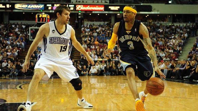 Allen Iverson dribbles around Beno Udrih during the first quarter at Arco Arena.