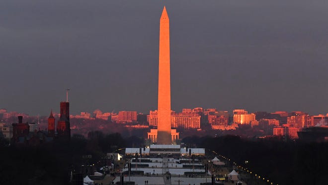 The sun rises over the Washington Monument ahead the 2017 Presidential Inauguration at the U.S. Capitol.