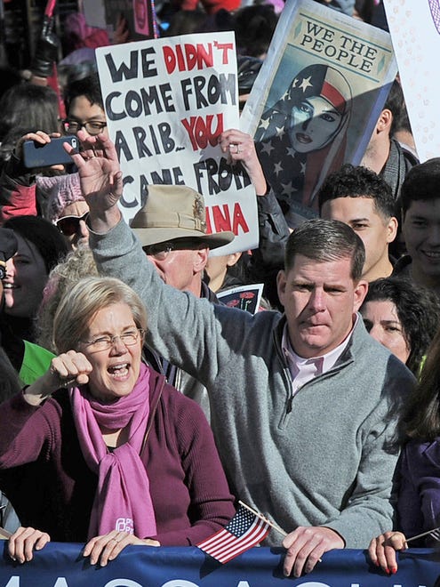 Senator Elizabeth Warren and Boston Mayor Martin Walsh wave to the crowds while walking in the Boston Women's March For America on Beacon St. on Saturday.
