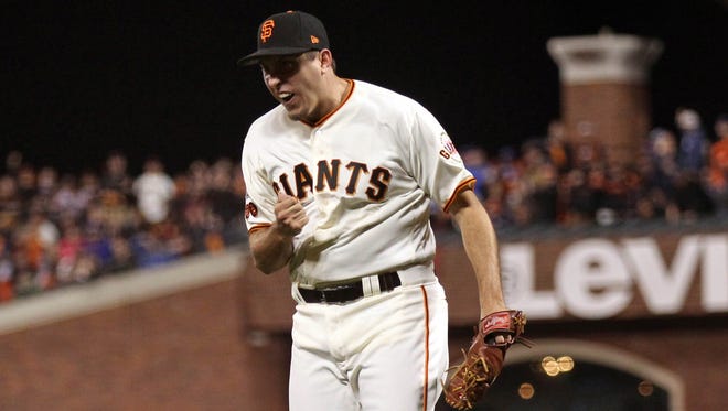 Game 3 in San Francisco: Giants relief pitcher Derek Law reacts after getting the final out in the fifth inning.