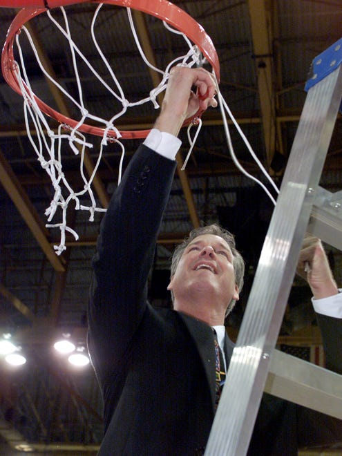 3/7/00  Butler head coach Barry Collier cuts his share the net after the Bulldogs victory over Detroit in the MCC Championship game at the UIC Pavillion in Chicago Tuesday night.  Photo...Rich Miller  (w/story  slug: butler08)