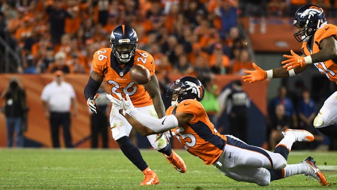 Denver Broncos cornerback Chris Harris (25) dives for an interception in the fourth quarter against the Carolina Panthers.