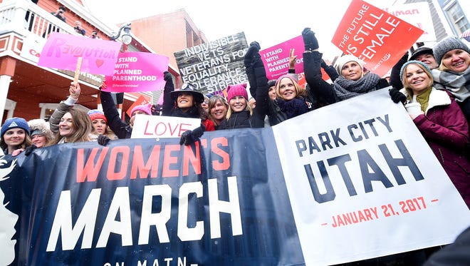 Jennifer Beals (holding Love sign), Chelsea Handler, Maria Bello and Charlize Theron march in the middle with others, on Jan. 21, 2017, participates in the Women's March on Main Street in Park City, Utah.