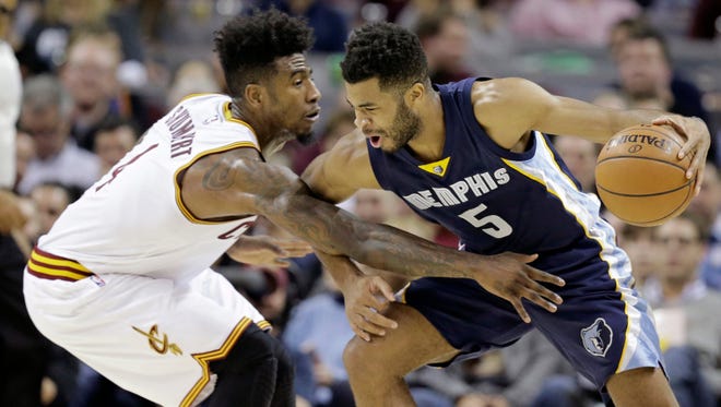 Memphis Grizzlies' Andrew Harrison (5) drives past Cleveland Cavaliers' Iman Shumpert (4) in the first half of an NBA basketball game Tuesday, Dec. 13, 2016, in Cleveland. (AP Photo/Tony Dejak)