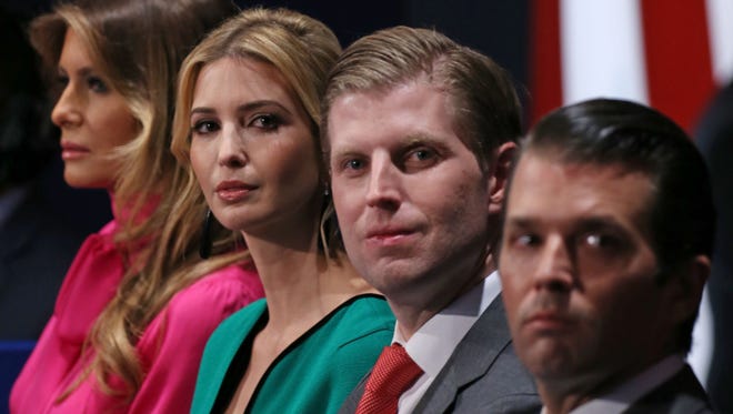 Donald Trump's wife  Melania Trump, left, his daughter Ivanka, and sons Eric and Donald Jr., listen to the second presidential debate at Washington University in St. Louis, Mo.
The new first family is a tight-knit celebrity clan, wealthy beyond the wildest dreams of most Americans and well used to the public eye.