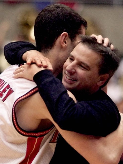 Iowa State coach Larry Eustachy hugs Paul Shirley (45) in the closing seconds of the Cyclones' Big 12 title game win after defeating Nebraska on Saturday, March 3, 2001.