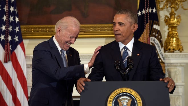 Biden laughs as Obama talks about him during a ceremony in the State Dining Room of the White House on Jan. 12, 2017. Obama surprised Biden and presented him with the Presidential Medal of Freedom.