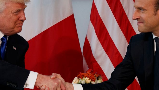 President Donald Trump shakes hands with French President Emmanuel Macron during a meeting at the U.S. Embassy, Thursday, May 25, 2017, in Brussels.