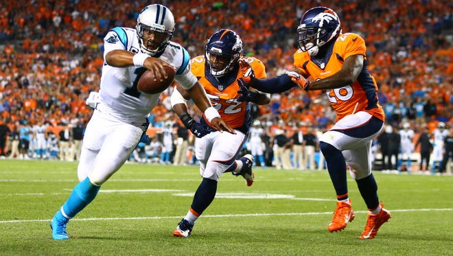Carolina Panthers quarterback Cam Newton goes in for a rushing touchdown against the Denver Broncos.