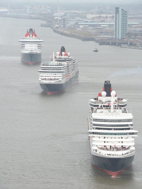 Queen Mary 2, Queen Victoria and Queen Elizabeth meet in the Mersey, Liverpool for a gathering in front of the Three Graces and thousands of people on the riverside.