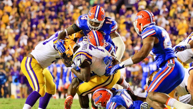 LSU running back Leonard Fournette is tackled by Florida defenders during their game in 2015.