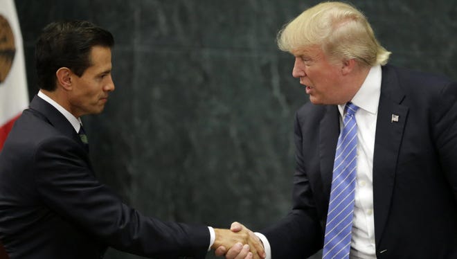Mexican President Enrique Pena Nieto, left, and U.S. presidential candidate Donald Trump shake hands after a meeting in Mexico City on Aug. 31.