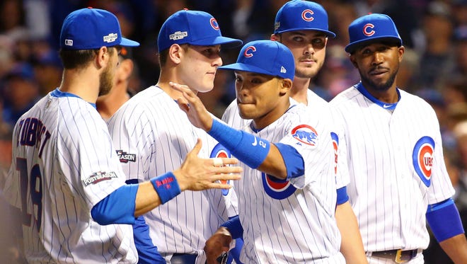 Game 1 in Chicago: Cubs shortstop Addison Russell greets left fielder Ben Zobrist as the lineup is announced.