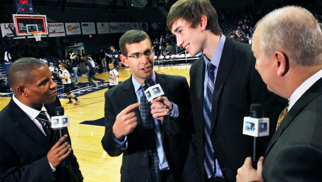 Butler University Head Basketball Coach Brad Stevens, second from left, points to Butler player-turned pro Gordon Hayward, now with the Utah Jazz during an interview with play-by-play announcer Anthony Calhoun, left, and color analyst Ralph Reiff, right, following Butler's 57-42 win over Savannah State in a Hoosier Invitational game at Hinkle Fieldhouse in Indianapolis on Monday, November 21, 2011. Hayward, who is awaiting the end of the NBA lockout, worked the game as a guest analyst for WNDY-23's televised broadcast of the game. Charlie Nye / The Star.