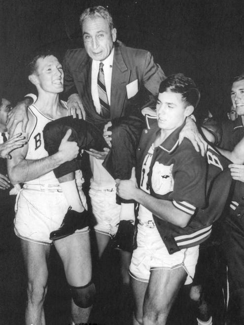 Butler Coach Tony Hinkle is carried from the floor Saturday night, Dec. 19, 1965 after his Bulldogs beat Indiana State, 76-70, notching HinkleÕs 500th victory in a 37-year basketball coaching career at Butler.