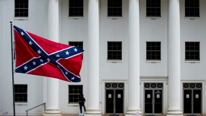 A Confederate Flag is raised on the back of a parked truck during a Confederate Memorial Day service outside the Alabama Capitol on Monday, April 24, 2017, in Montgomery, Ala.