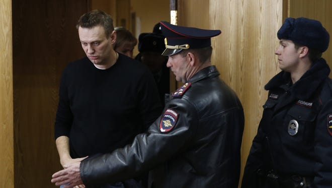Russian opposition leader Alexei Navalny enters a courtroom to hear the verdict in Moscow on March 27, 2017. Navalny, who organized a wave of nationwide protests against government corruption that rattled authorities, was fined 20,000 rubles ($340) on Monday by a Moscow court. It was a comparatively lenient punishment for organizing an unsanctioned rally for which he faced up to 15 days in jail. The court has yet to deliver its ruling on charges accusing the opposition leader of resisting arrest.