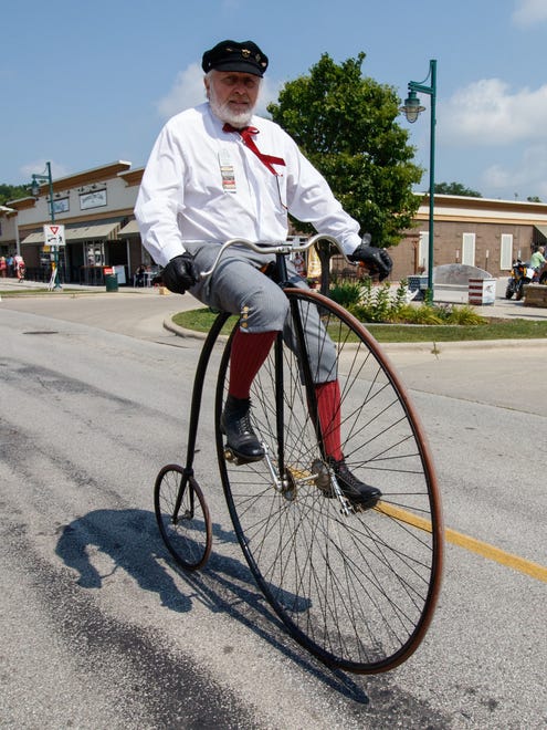 Jim Guthrie of Mequon rides past on a vintage bicycle during the 13th Annual Antique & Classic Boat Show at Pewaukee's Lakefront Park on Saturday, August 19, 2017. Guthrie is a member of the Wheelmen organization which is dedicated to keeping alive the heritage of American cycling.