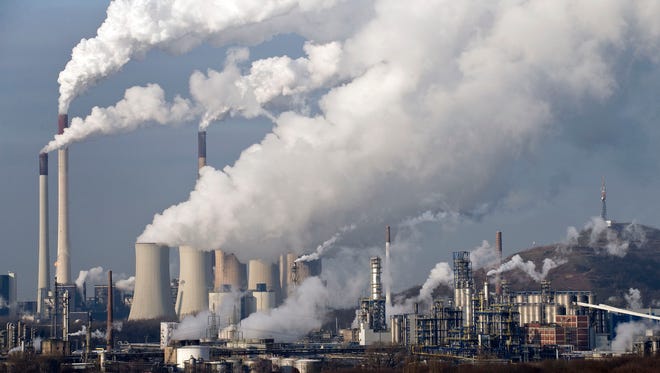 In this Wednesday, Dec. 16, 2009 file photo, steam and smoke rises from a coal-burning power plant in Gelsenkirchen, Germany.