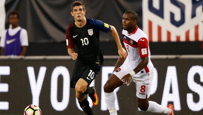 United States midfielder Christian Pulisic (10) dribbles the ball in the first half as Trinidad & Tobago midfielder Khaleem Hyland (8) defends at EverBank Field.
