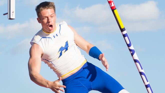 Bailey Kroll of Mukwonago celebrates clearing 14 feet in the pole vault while still in the air.