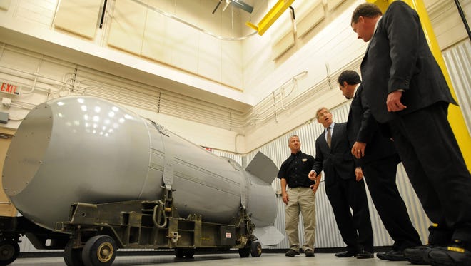 A weapons trainer talks to U.S. Energy Department officials Oct. 25, 2011, during an event commemorating the dismantling of the final B53 nuclear bomb at the Pantex Plant in Amarillo, Texas.
