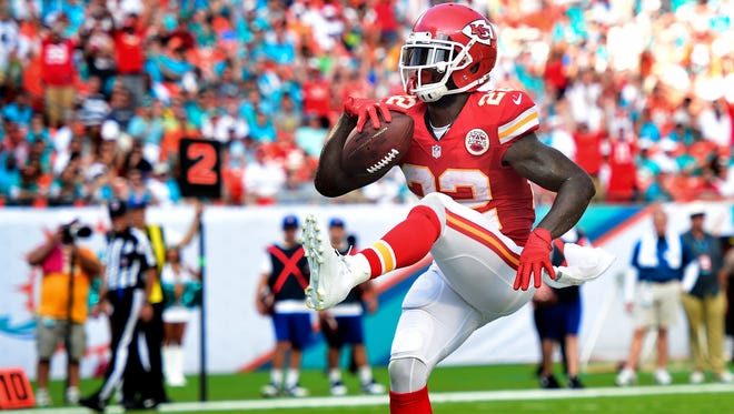 Kansas City Chiefs running back Joe McKnight (22) scores a touchdown against the Miami Dolphins in the game at Sun Life Stadium in 2014.