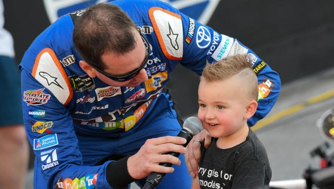 Kyle Busch and son Brexton during driver introductions before the Bass Pro Shops NRA Night Race at Bristol Motor Speedway.