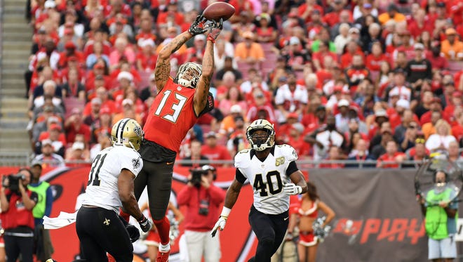 Buccaneers wide receiver Mike Evans (13) drops a pass in the first half against the Saints.