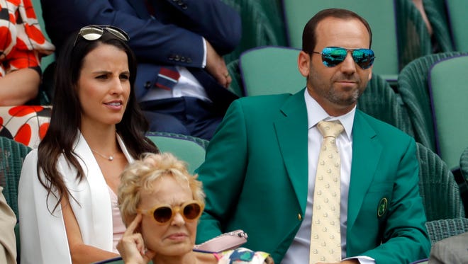 Golfer Sergio Garcia, wearing his Green Jacket from the Masters, and fiancee Angela Akins in the Royal Box at Wimbledon.
