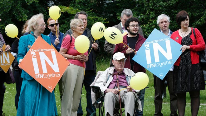 Liberal Democrat supporters gather in a park for a "Remain" rally by Liberal Democrat Leader Tim Farron in Carshalton on June 21, 2016.