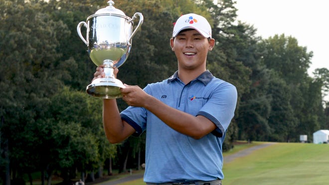 Si Woo Kim poses with the Sam Snead trophy after winning the 2016 Wyndham Championship. at Sedgefield Country Club.