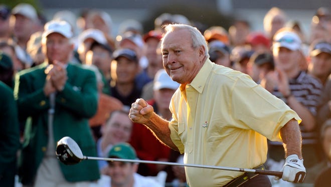 In a file photo from 2009, Arnold Palmer follows through on his tee shot to open the 2009 Masters.