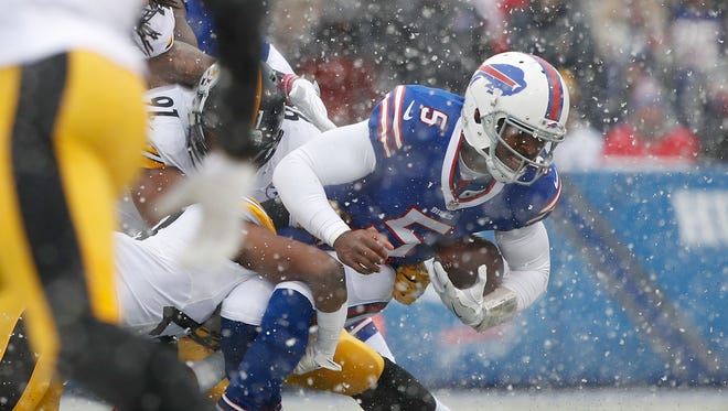 Buffalo Bills quarterback Tyrod Taylor (5) is sacked by Pittsburgh Steelers safety Sean Davis (28) and defensive end Stephon Tuitt (91) during the first quarter at New Era Field.