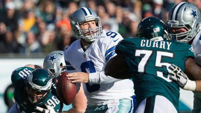 Dallas Cowboys quarterback Tony Romo (9) passes past the rush of Philadelphia Eagles defensive end Vinny Curry (75) and defensive end Connor Barwin (98) during the second quarter at Lincoln Financial Field.