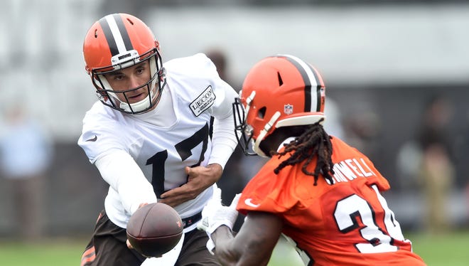 Cleveland Browns quarterback Brock Osweiler (17) hands off to running back Isaiah Crowell (34) during organized team activities at the Cleveland Browns training facility.