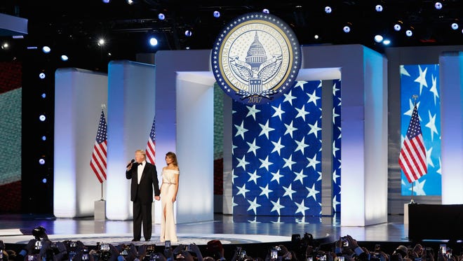 President Donald Trump and first lady Melania Trump address the Freedom Inaugural Ball at the Washington Convention Center in Washington.