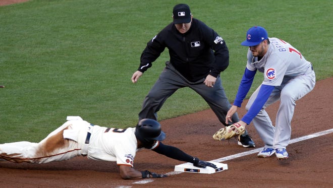 Game 4 in San Francisco: Giants center fielder Denard Span slides into third base during the first inning.