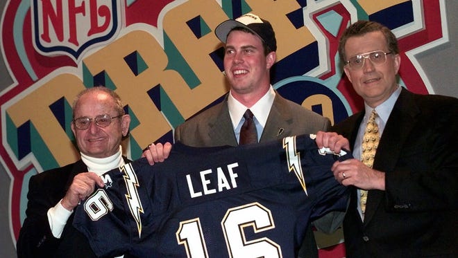 Ryan Leaf, center, celebrates being drafted No. 2 overall by the San Diego Chargers along with team owner Alex Spanos, left, and NFL Commissioner Paul Tagliabue.
