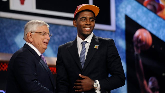 2011: David Stern poses with the No. 1 overall draft pick Kyrie Irving.