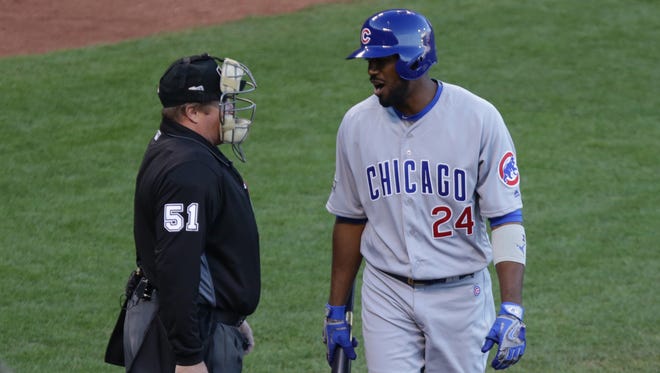 Game 4 in San Francisco: Cubs center fielder Dexter Fowler talks to umpire Marvin Hudson after a call during the first inning.