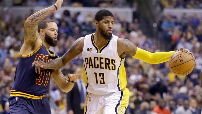 Indiana Pacers forward Paul George (13) holds off the defending Cleveland Cavaliers guard Deron Williams (31) in the first half of their NBA playoff basketball game Sunday, April 23, 2017, afternoon at Bankers Life Fieldhouse.