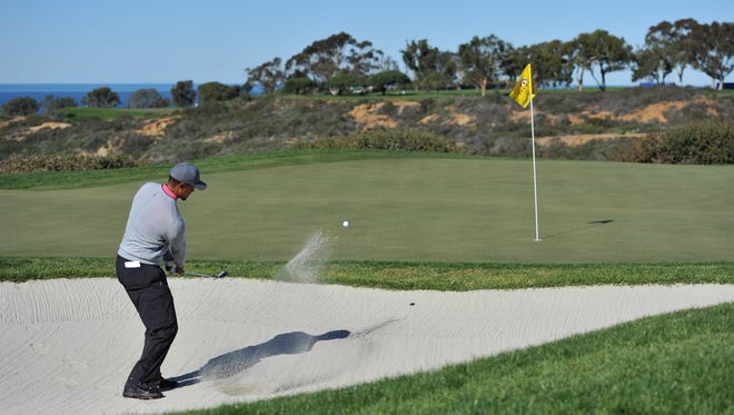 Tiger Woods plays his shot out of a sand trap on the 12th hole during the second round of the Farmers Insurance Open golf tournament at Torrey Pines Municipal Golf Course - North Co.